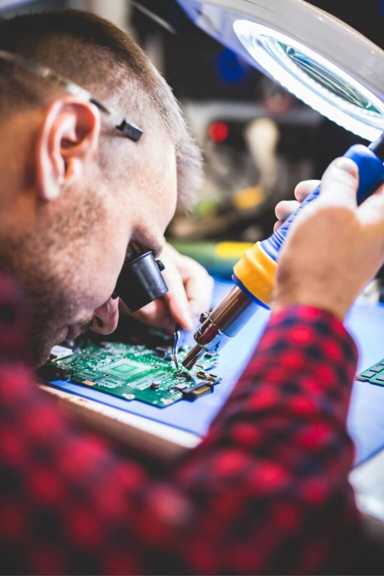 man-soldering-motherboard-at-workplace